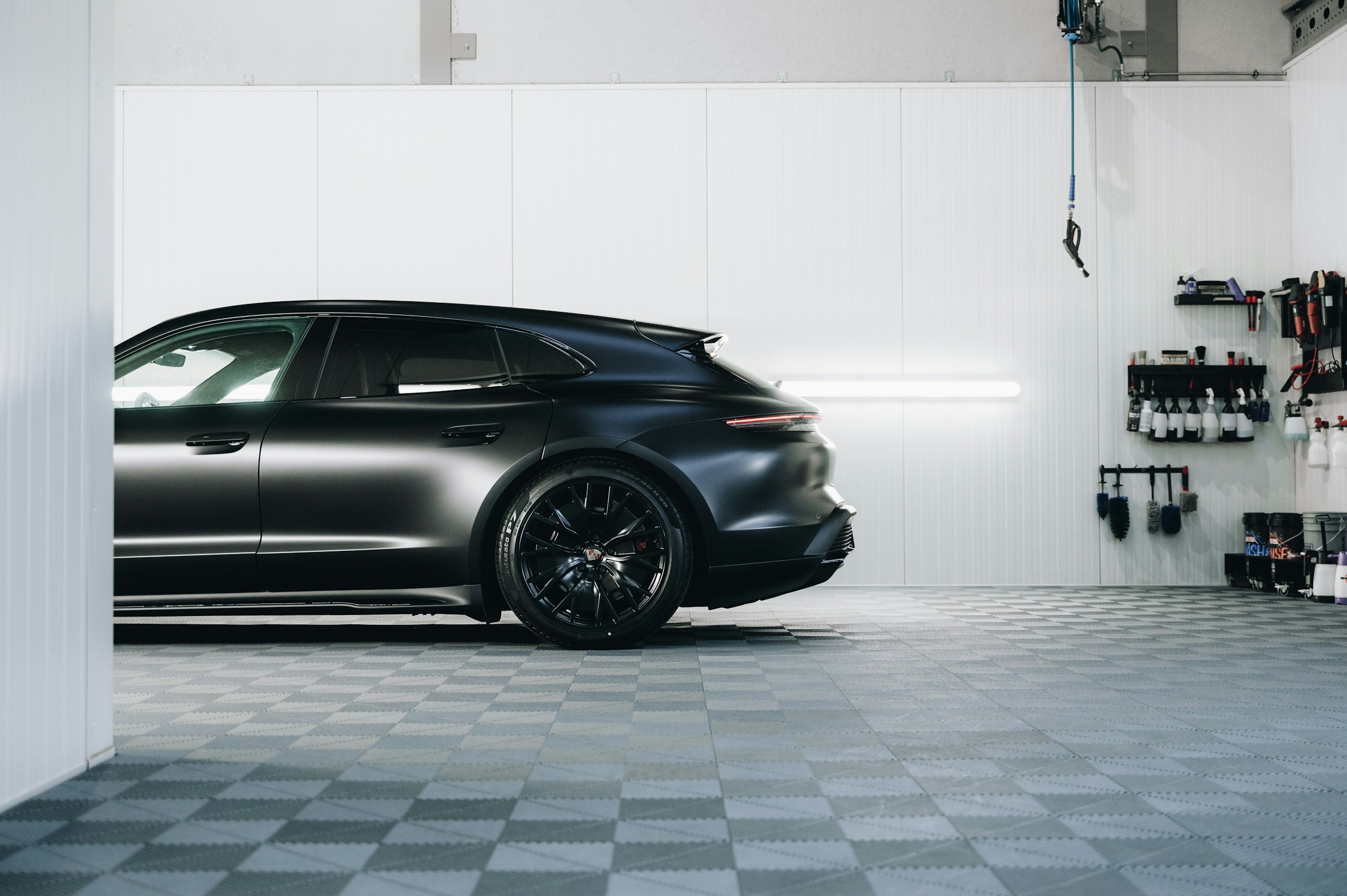 Black sports car in a workshop